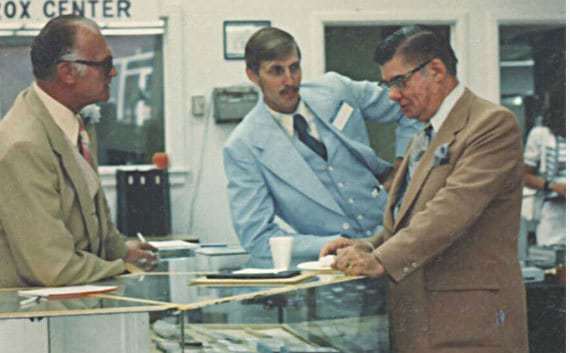 Clyde & Len interact with a client at the 1975 open house.